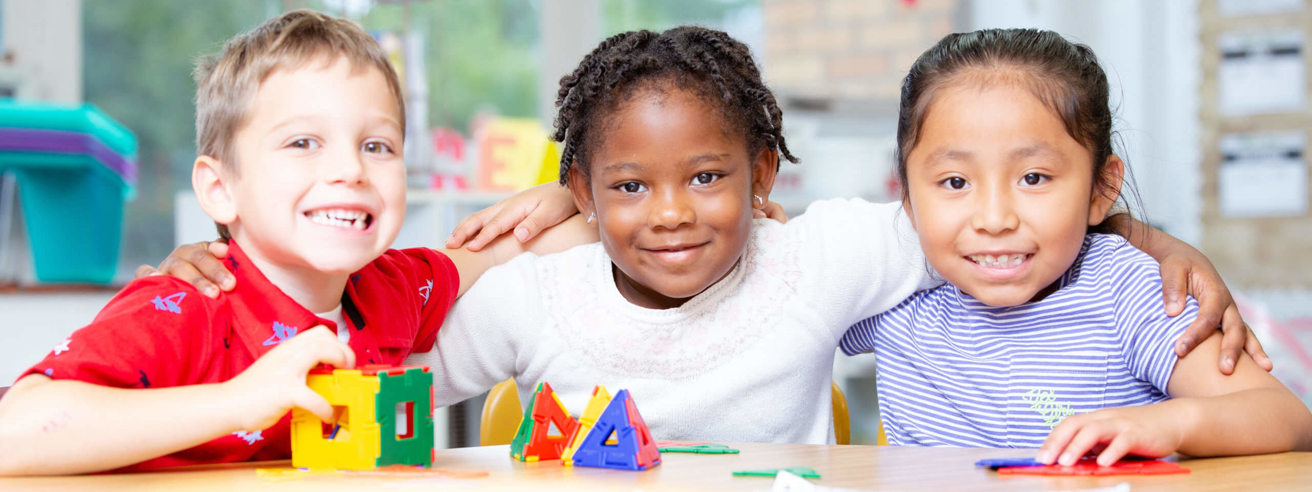 3 Students in class with building blocks