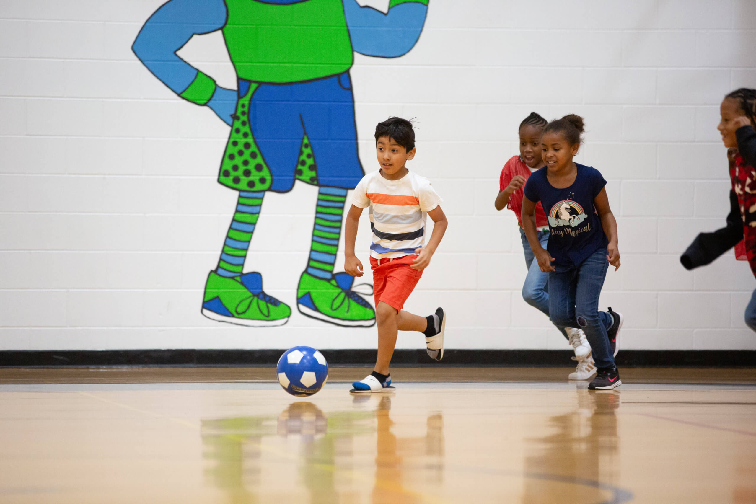 Students playing soccer in gym