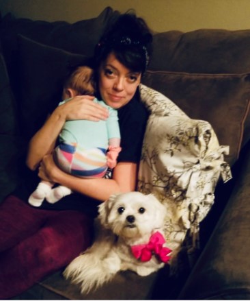 Tiffany Gumpert posing for a picture with her child and her dog.