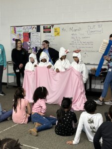 New Branches Charter Academy students participate in a presentation from a local orthodontist by dressing as teeth and showing proper hygiene tactics